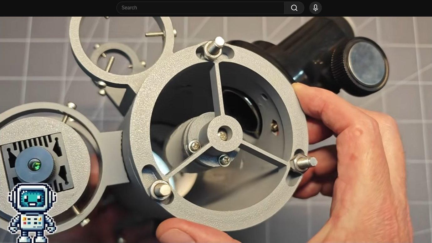 Telescope assembly held in hand showing mounting mechanism