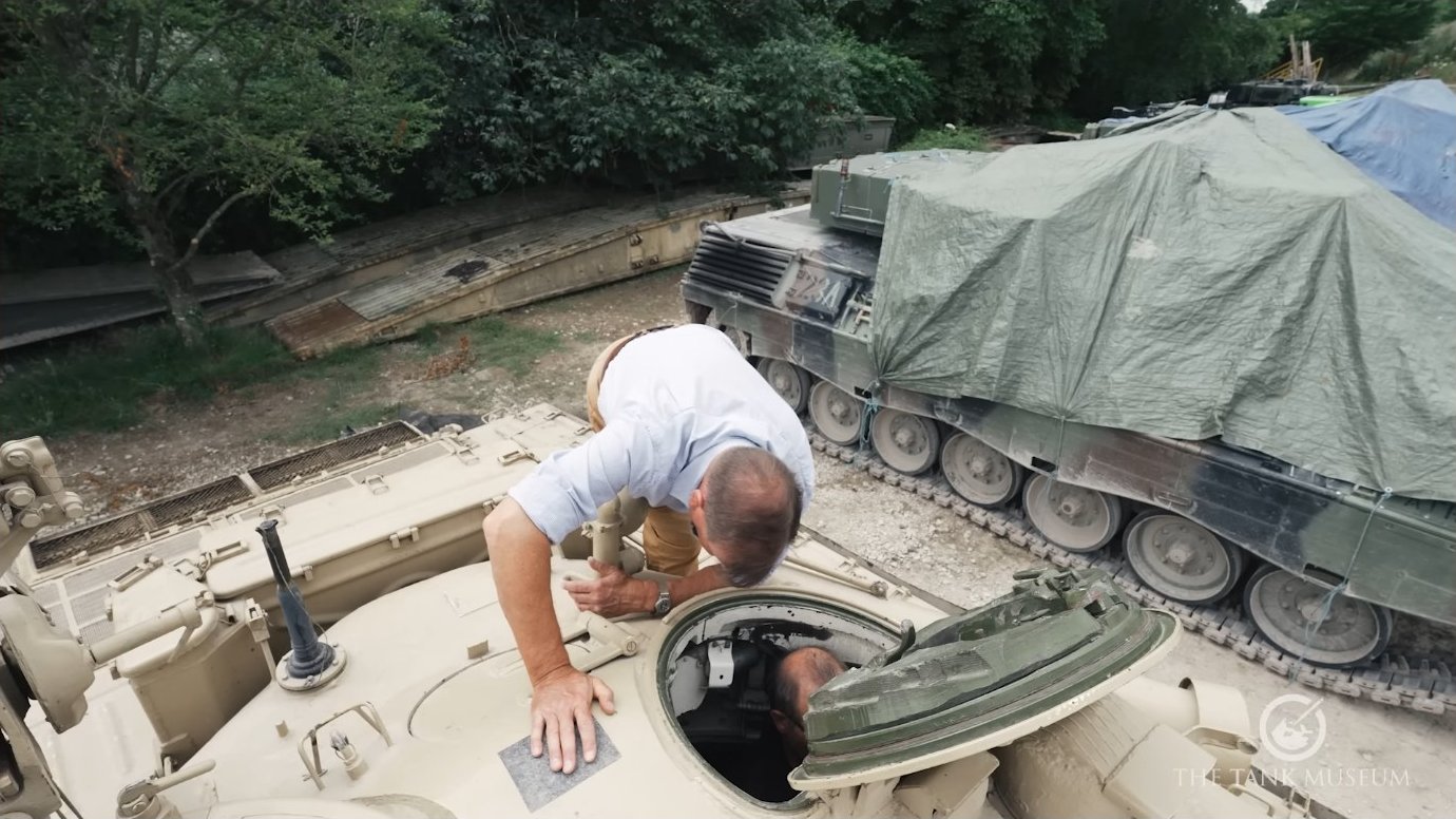 Entering the turret through the commander's hatch. The confined space becomes familiar with experience, and crew members learn to move efficiently within tight tolerances.