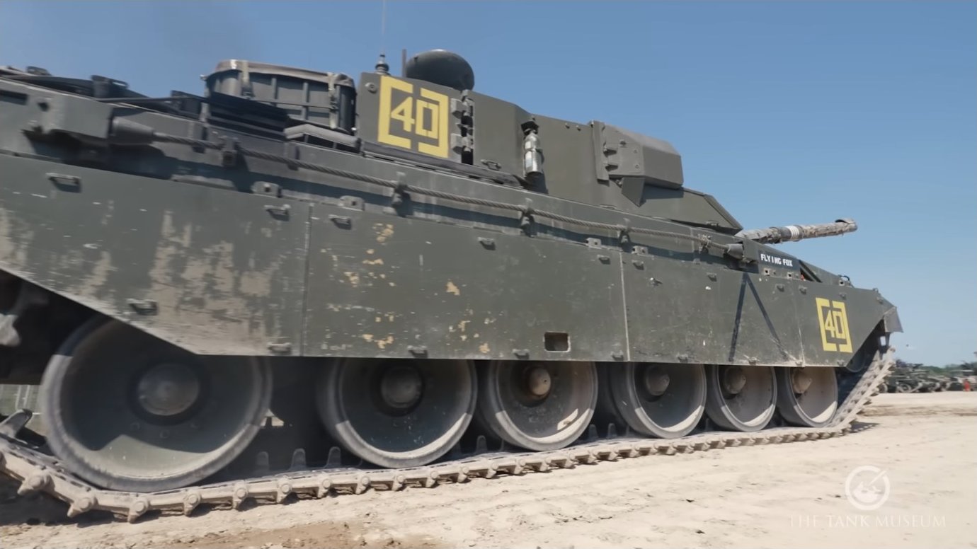 The T-72's 125mm smoothbore main gun and external track configuration. The vehicle's low center of gravity and wide stance contribute to stability during high-speed maneuvers.