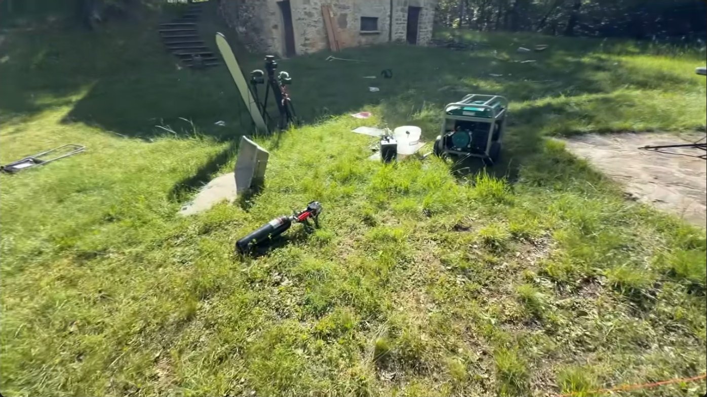 The cannon assembly lying on the ground after being thrown backward by recoil, demonstrating the enormous momentum transfer that occurs during firing and the engineering challenges of scaling up further.