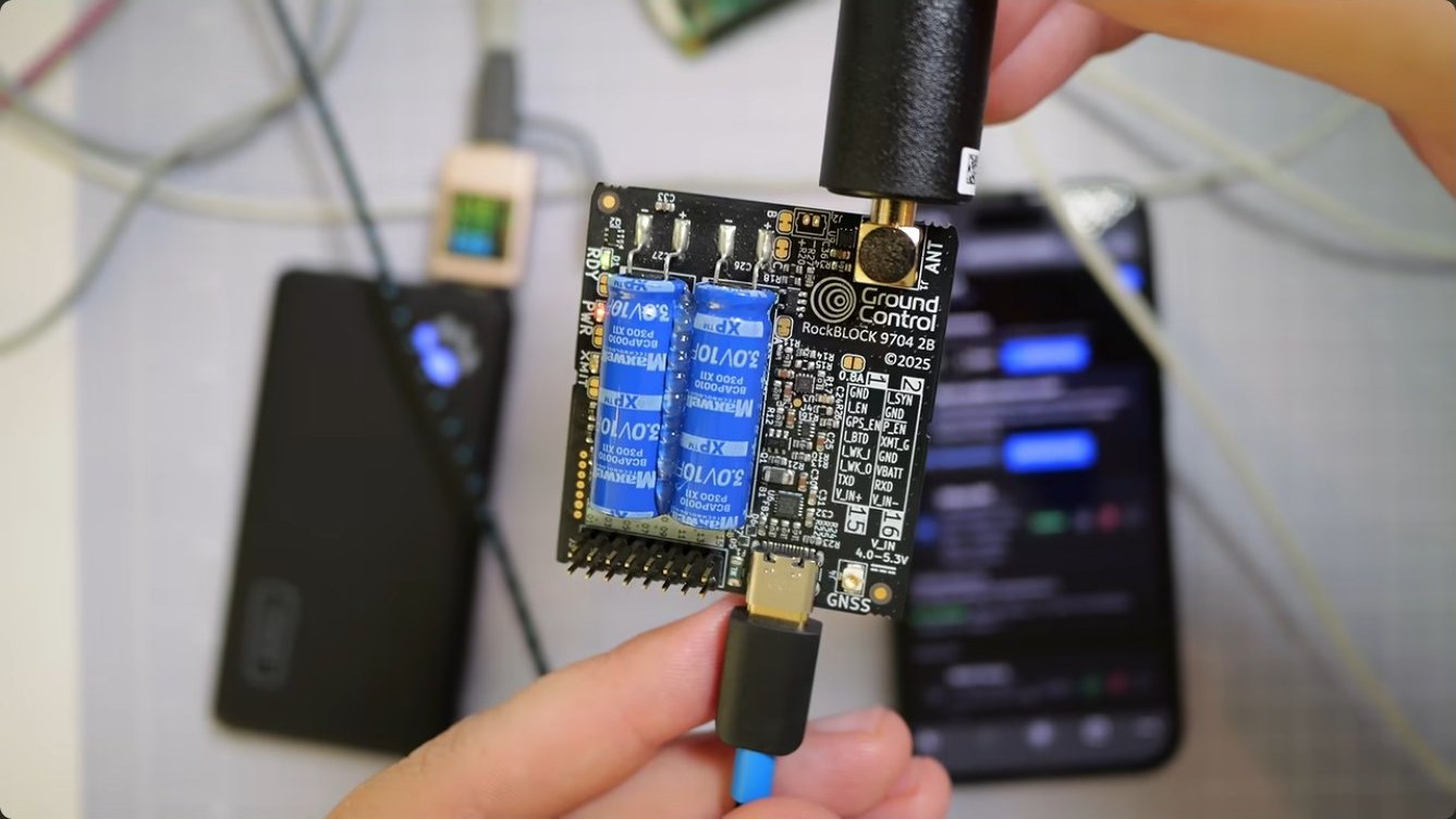 The RockBLOCK 9704 board with SMA antenna connector, USB-C, and the two blue supercapacitors.
