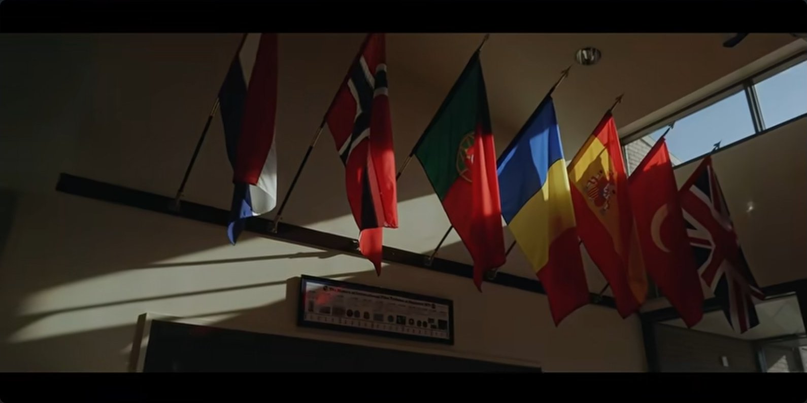 Member-nation flags hanging in the training building — the daily reality of coalition training.