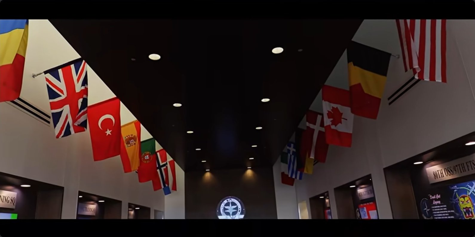Flags of the member nations line the corridors of the training wing.